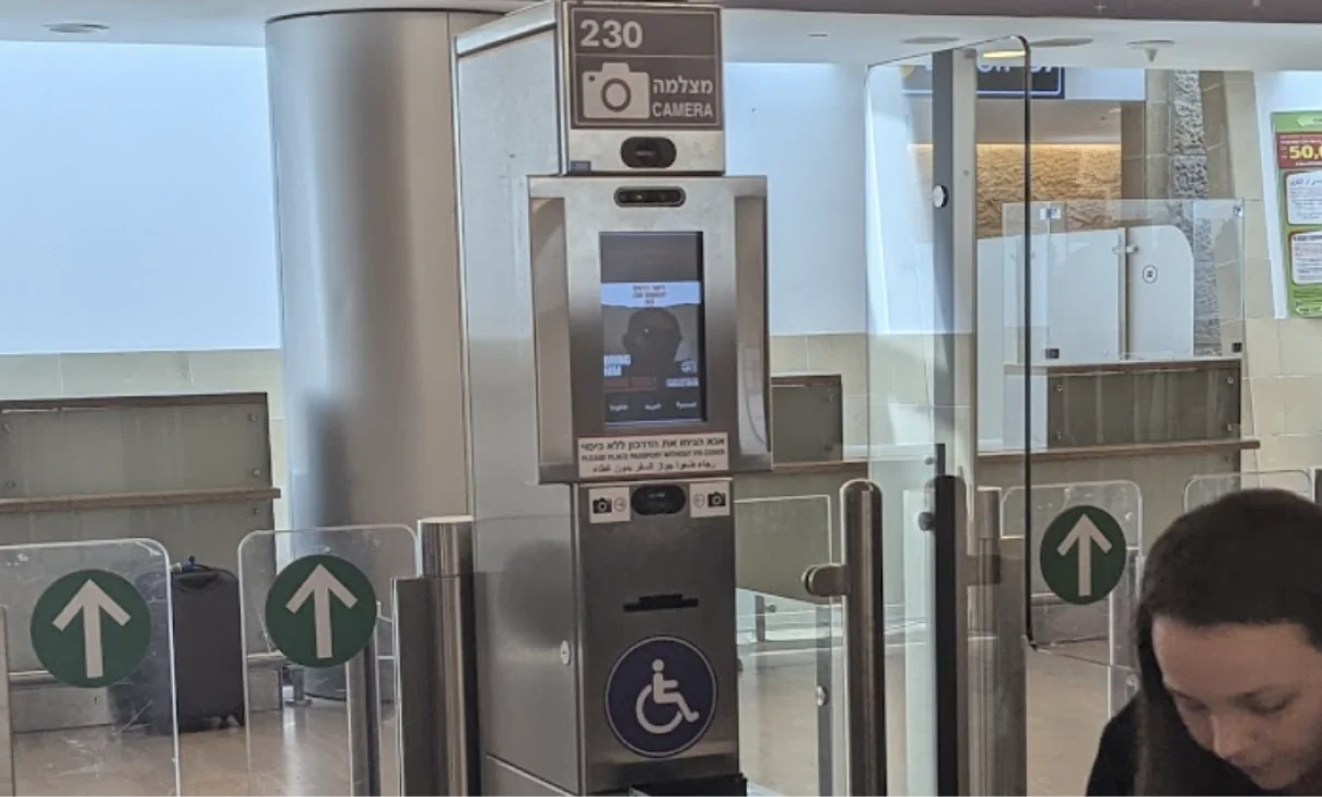 Border control gates with the face camera and green arrow signs